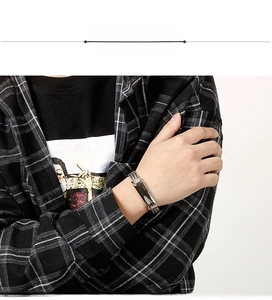 Detail of silver titanium steel woven chain bracelet worn on a male model wrist
