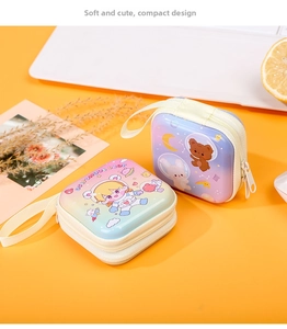 Detail of square tinplate coin purses featuring astronaut bear and bunny cartoon designs