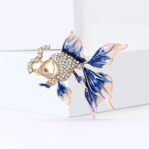 Elegant goldfish brooch with sparkling rhinestones and enamel fins on a white background
