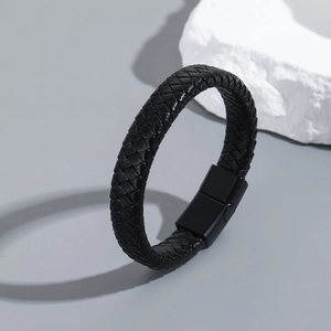 Close-up of men's braided leather bracelet with matte black magnetic metal clasp