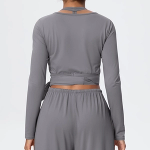 Detail of grey yoga set featuring back cross-strap design and brushed matte fabric texture
