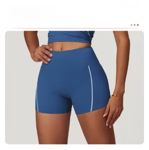 Detail view of royal blue high waist yoga shorts with white contrast stitching