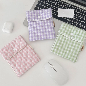 Detail view of quilted cotton mini pouches in pink, purple and green with snap closure