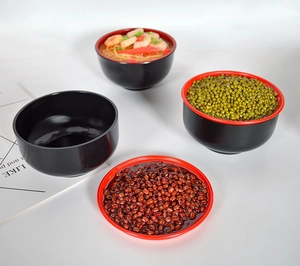 Deep red and black lacquer style bowls and plate set showing food storage capacity