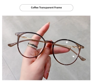 Detail of coffee transparent round frame glasses with golden metal temples and model text