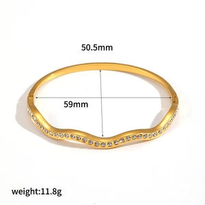 18k gold plated stainless steel wavy open bangle featuring dense white rhinestones