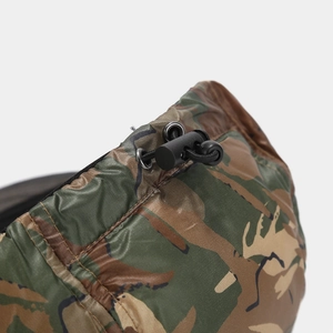 Detail of outdoor camo cap showing elastic drawstring, plastic cord lock and metal eyelet