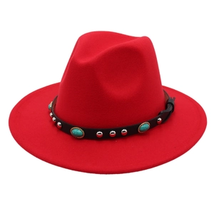 Detail of red fedora hat with turquoise stone and silver stud embellished band