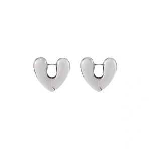 Macro detail of silver heart hoop earrings with a polished mirror finish and hidden clasp