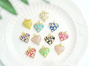 Close-up of 18K gold plated heart charms with colorful enamel and micro-pave crystals