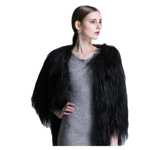 Chic black long-haired faux fur coat for women paired with a grey knit dress