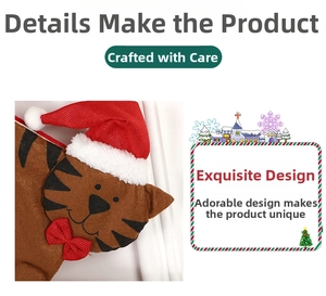 Detail of a brown fabric cat Christmas stocking featuring a red hat and festive bow