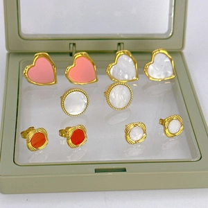 Vintage style earring set with heart and pearl designs in a light green jewelry box