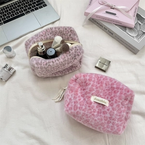 Detailed top view of leopard print plush cosmetic bags with a soft girl aesthetic setup