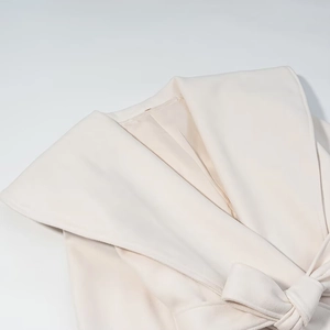 Elegant beige wool blend coat featuring large lapels and adjustable waist tie belt