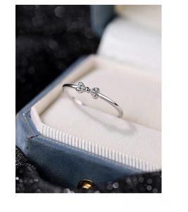 Close-up of S925 silver bow ring with micro-set zircons in a premium blue velvet box