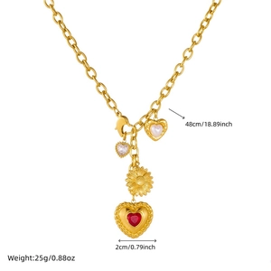 Gold-plated vintage necklace with sunflower, crystal and heart pendants on white background