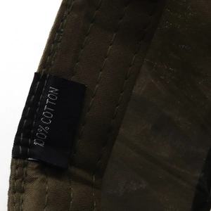 Close-up of olive green cotton baseball cap featuring reinforced stitching and 100% cotton label