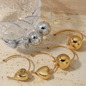 Polished gold and silver C-shaped hoop earrings with hollow heart and sphere charms