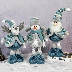 Three Christmas plush dolls reindeer snowman and gnome set on snow background