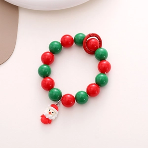 Detailed view of Christmas phone strap with red green beads and Santa Claus pendant