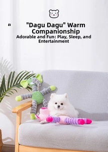 Detail of plush squeaky elephant and pig dog toys on a sofa with a white Pomeranian dog