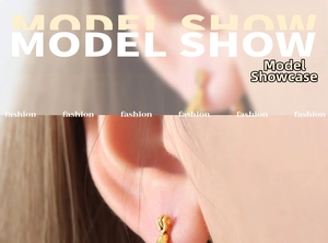 Close-up of golden Ruyi koi fish earrings worn by a model in a minimalist style