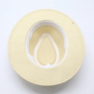 Close-up of beige straw panama hat interior showing sweatband and fine weaving