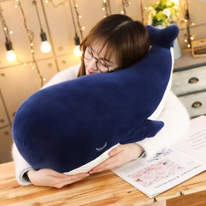Soft giant blue whale plush toy hugged by a girl in a cozy and warm indoor setting