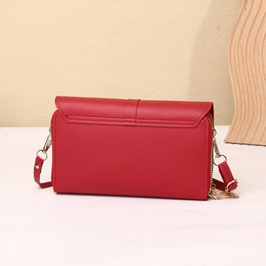 Detail view of the red lychee pattern PU leather phone bag with golden zipper and strap