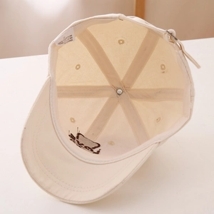 Detail view of cotton baseball cap interior showing 100% cotton label and sweatband