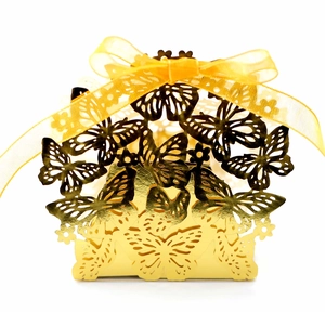 Detailed laser-cut gold butterfly gift box featuring a metallic finish and silk ribbon bow