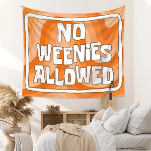 Detail of bohemian orange wavy tapestry with No Weenies Allowed text in a cozy bedroom decor
