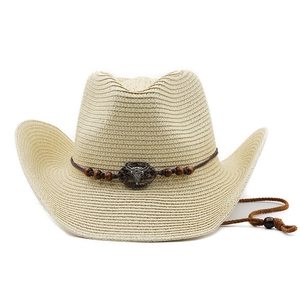 Detail of beige straw cowboy hat with leather cord, wooden beads and silver bull skull ornament