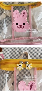 Detail of transparent PVC backpack with pink bunny patch and cartoon hand zipper pull