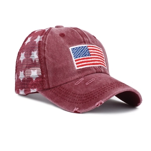 Close-up of vintage American flag embroidery and mesh on a washed ponytail baseball cap
