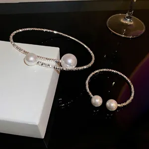 Silver textured choker and open bangle set featuring large white pearls in a modern style