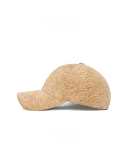 Detail of beige quilted corduroy baseball cap showing textured fabric and side profile