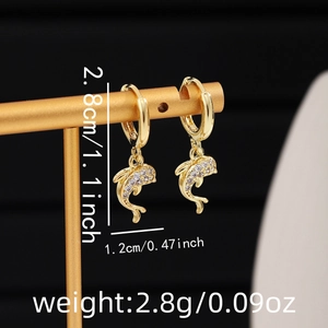 Macro shot of gold dolphin hoop earrings with white zircon pavé and product dimensions