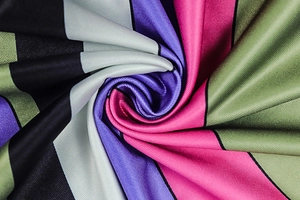 Macro view showing silky striped fabric texture with colorful diagonal patterns