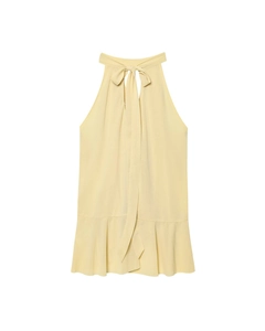 Detail of light yellow halter neck top with bow tie and ruffled hem on white background