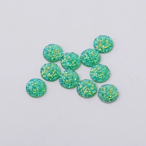 Macro shot of 12mm green resin flatback rhinestones with sparkling druzy texture