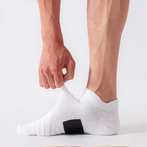 Detail shot showing the high elasticity and stretch of the white athletic crew socks