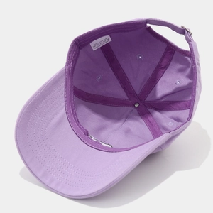 Detail view of cotton baseball cap interior with purple stitching and adjustable metal buckle