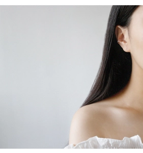 Close-up of elegant double-layered silver ear cuff on model for a chic minimalist look