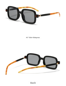 Detail view of square black sunglasses with orange tortoiseshell textured temples