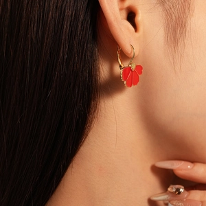 Retro red oil drop flower petal hoop earrings in gold finish worn by a model