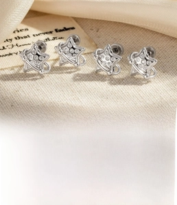 Detailed view of silver star stud earrings featuring 0.8x6mm titanium steel posts
