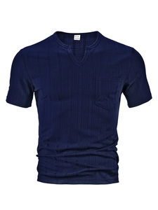Detail view of navy blue V-neck knit shirt showing textile texture and chest pocket