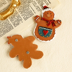 Gingerbread man resin Christmas fridge magnet with double magnets on textured background